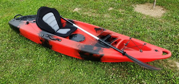 Closeup of red kayak with paddle and seat